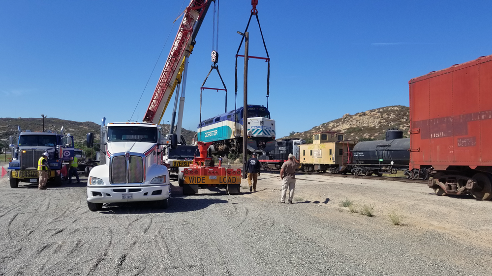 Coaster 2103 Delivery_CPO Nearly home, SDNX 2103 is lifted off the dollies and back onto the rails at Campo, CA.